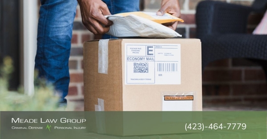 Person stealing packages from a homeowner's porch